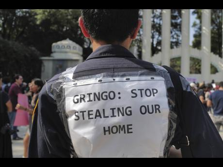 People protest against Americans’ gentrification of parts of Mexico City.
