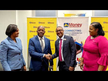 Credit: Contributed Pearnel Charles Jr (second left), minister of labour and social security, greets Horace Hines (second right), general manager of JN Money Services Limited, following the launch of the inaugural Fields of Opportunity Scholarship. Looking on are Dione Jennin