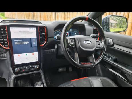 The driver-focused cockpit, with its large infotainment display and subtle performance-oriented details.
