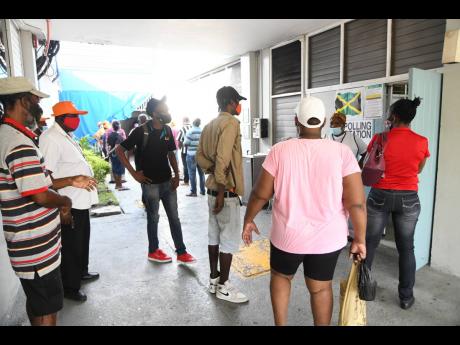Credit: File In this September 2020 photo, voters are seen gathered outside the polling station at Jamaica German Automotive in St Andrew East Central.
