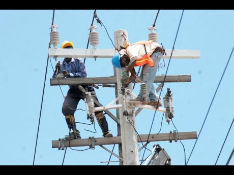 
In this file photo, JPS linesmen are seen carrying out repairs on power lines.