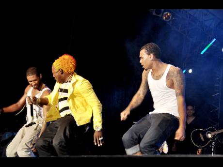 Credit: File Usher (left) is joined on stage by Elephant Man (centre) and Chris Brown on the final night of the Reggae Sumfest 2010.