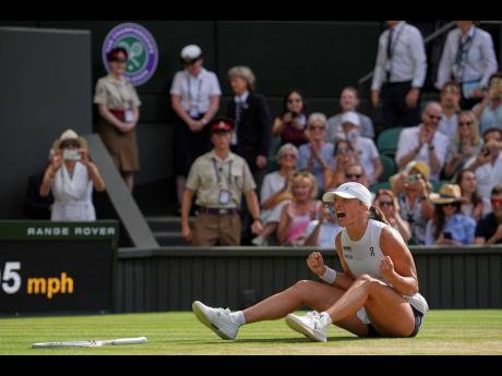 
Poland’s Iga Swiatek celebrates after beating Amanda Anisimova of the United States to win the women’s singles final at the Wimbledon Tennis Championships in London yesterday.