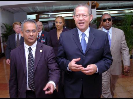 Then Prime Minister of Jamaica Bruce Golding (right) in discussion with Ambassador Albert Ramdin, assistant secretary general of the  Organization of American State, at the opening of the Third General meeting of the Association of Caribbean Electoral Orga