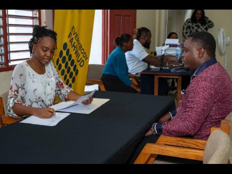 Tashna Smith (left), human resource officer at Hotel39 in Montego Bay, interviews Delvin Sterling at the recent Project STAR Job Fair in Salt Spring, St James.