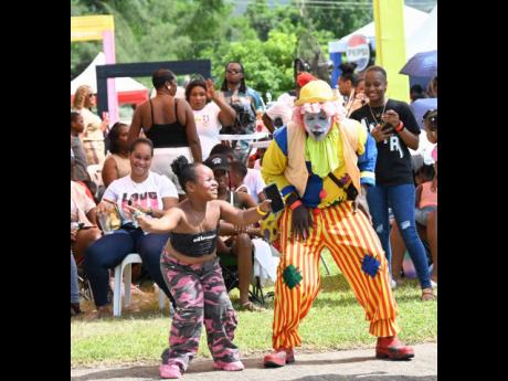 Credit: Ashley Anguin Azariah Robinson and Mark Williams share some dance moves during the Reggae Sumfest Family Fun Day held on Sunday at the Catherine Hall Stadium in Montego Bay.