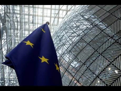 The European Union flag stands inside the atrium at the European Council building in Brussels.