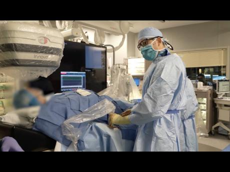 Credit: Dr Khalili Houman, interventional cardiologist, prepares to perform a procedure on a patient at Memorial Cardiac and Vascular Institute in South Florida.