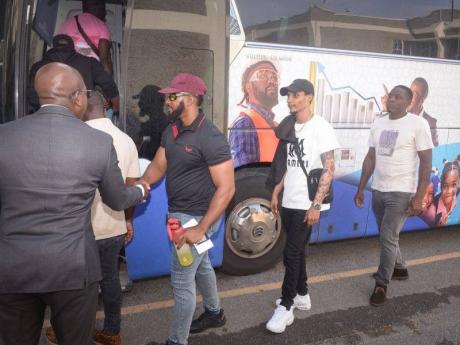Minister of Labour and Social Security, Pearnel Charles Jr (left), sends off workers departing the island to take up employment opportunities in North America. The departure ceremony was held on Tuesday (July 15) at the Ministry’s Overseas Employment Cen