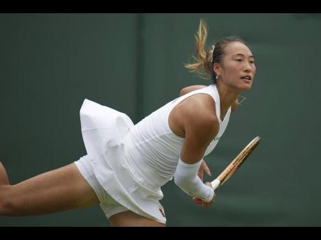 
Zheng Qinwen of China serves to Katerina Siniakova of the Czech Republic in a first-round women’s singles match at the Wimbledon Tennis Championships in London, on Tuesday, July 1.