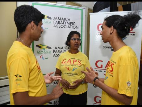 
Former para-athlete Sharmella Martin (centre) speaks with her epee and sabre fencer sons Dylan Martin (left), and Shea Martin.