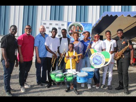 Credit: Contributed Rajay Robinson, one of the younger marching drums players, is surrounded by (from left) Jeffrey Brown, band camp director; Steve Wilson, co-manager of Sean Paul; Craig Moss-Solomon, FFP executive director; Daniel Durrant; Tijae Henry; Kivette Silvera exec
