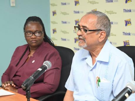 Clinical Coordinator at the Western Regional Health Authority (WRHA), Dr Delroy Fray (right) addressing a Jamaica Information Service (JIS) Think Tank held at the agency’s regional office in Montego Bay, St James on July 14. Looking on is WRHA’s Region