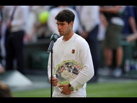 Carlos Alcaraz of Spain is interviewed holding his runner-up trophy after losing to Italy’s Jannik Sinner in the men’s singles final at the Wimbledon Tennis Championships in London on Sunday, July 13.