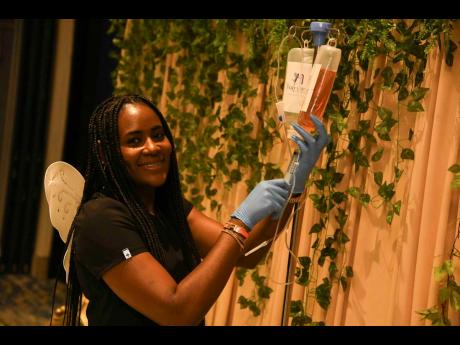 Registered nurse Shantae Wilson, CEO and founder of The Fairy Loft Med Spa, prepares the ‘Fairy Booster’ IV cocktail for a festival attendee at the Book Fairy Festival held earlier this month.