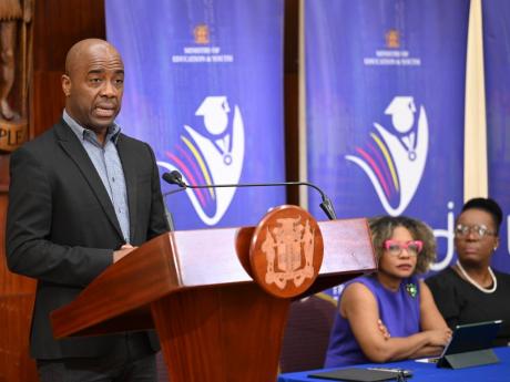 Education Transformation Oversight Committee (ETOC) Chairman, Dr Adrian Stokes (at podium), addressing a ETOC press conference at Jamaica House on July 23. Listening (from left) are Minister of Education, Skills, Youth and Information, Senator Dr Dana Morr