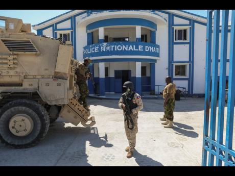 Haitian and Kenyan police who are part of a UN-backed multinational force stand at a police station in Pont-Sonde, Haiti, on October 7, 2024, days after a gang attacked the town. 