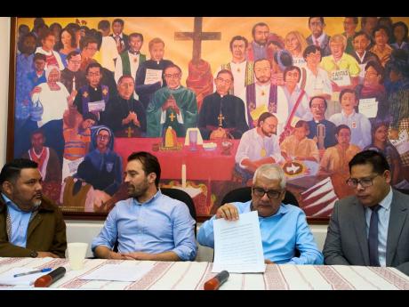 Members of the human rights organization Cristosal (from left), Rene Valiente, Noah Bullock, Abraham Abrego and Rafael Cruz, sit moments before giving their press conference in Guatemala City on July 17, to announce that Cristosal is suspending its activit