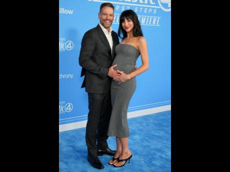 Ioan Gruffudd (left) cradles Bianca Wallace’s baby bump on the blue carpet.