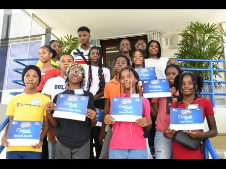 Participants in the JN Financial Academy summer camp last year show off their certificates.