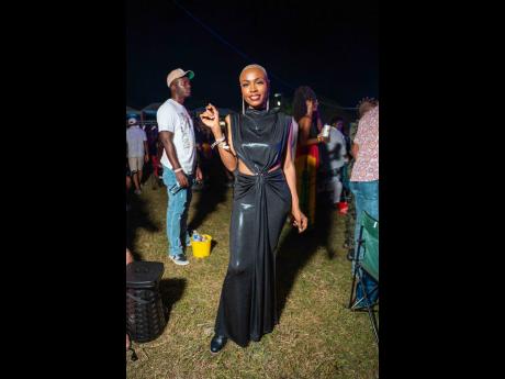 Wardrobe stylist Jane Michelle channels drama in a black draped maxi dress and matching boots.