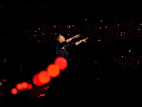 Chris Martin of Coldplay performs during the band's Music Of The Spheres World Tour at DY Patil Sports Stadium in Navi Mumbai, Saturday, January 18, 2025. (AP Photo/Rajanish Kakade, File)