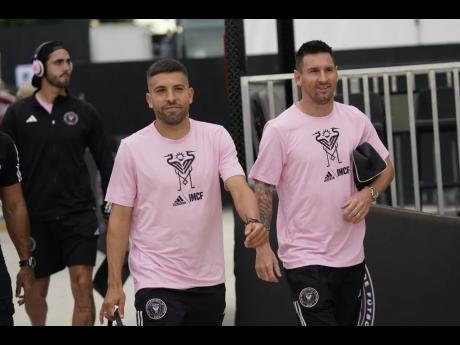 Inter Miami defender Jordi Alba (left) and forward Lionel Messi chat as they arrive before the start of an MLS match against Toronto FC on Wednesday, September 20, 2023, in Fort Lauderdale, Florida.