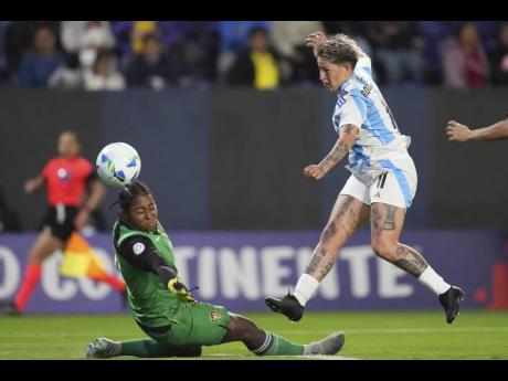 Yamila Rodriguez (right) of Argentina shoots the ball past goalkeeper Andrea Moran of Ecuador during a Women’s Copa America match in Quito, Ecuador, Thursday, July 24, 2025. 