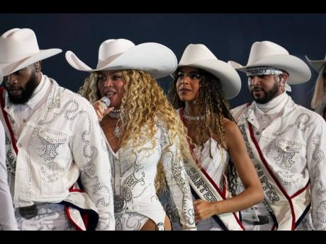  Beyoncé, (second left) and her daughter, Blue Ivy Carter, perform during halftime of an NFL football game between the Baltimore Ravens and Houston Texans in December 2024 in Houston. 