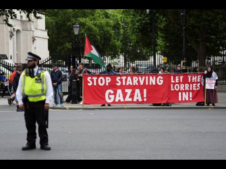People protest outside Downing Street in London yesterday, as Prime Minister Keir Starmer gathered senior ministers for an urgent Cabinet meeting on Gaza.