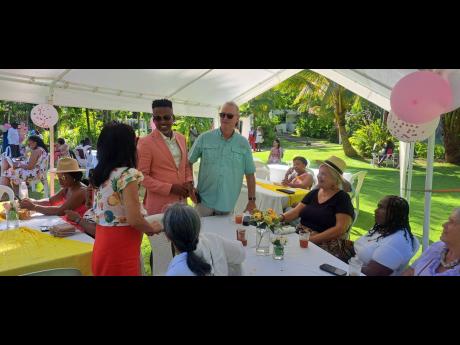 Orthopaedic spine surgeon Dr Kingsley Chin with guests at a tea party put on by Girls Becoming in Portland on Sunday. 
