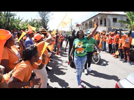 In this 2024 photo, JLP supporters are seen walking in Kellits as PNP supporters are lined up on the road.