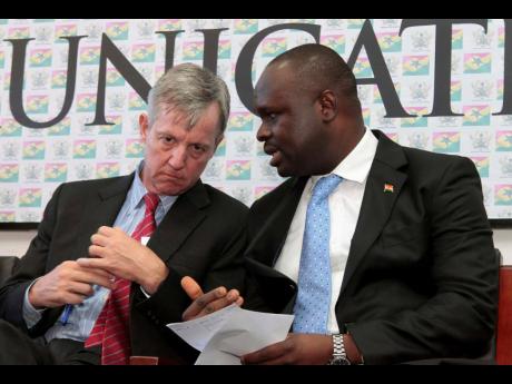 Edward Omane Boamah, Ghana's defence minister who was killed Wednesday in a helicopter crash along with several other top officials, is pictured on the right on September 30, 2014 when he was information minister and talking with UN official Anthony Banbur