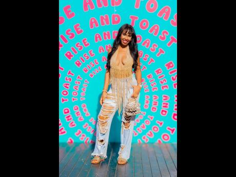 Pearl play meets street edge for stylist Kristia Franklin. The My Repeat Offender digital creator redefines brunch chic in a plunging pearl crop top and matching pearl-speckled jeans.
