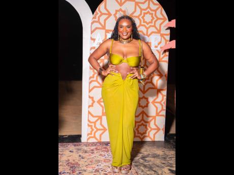 Nursing student Rochelle Martin commands attention in a warm, golden-hued cutout dress.