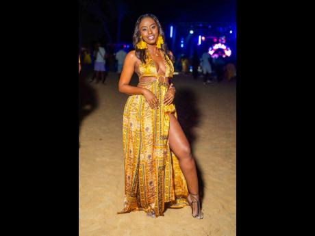 All glow, all grace — Nail technician Colleen Roberts radiates elegance in golden tones and a thigh-high slit made for the dance floor.