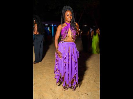 Publicist and marketer Colette Romany stands out in royal purple with coin-chain details.
