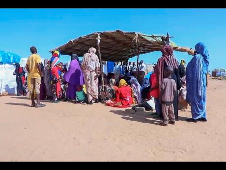 Credit: AP Sudanese refugees gather outside a field hospital in Acre, Chad.