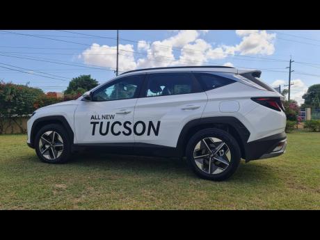 The Tucson’s profile showcases its athletic stance and flowing lines, creating a sense of forward motion.
