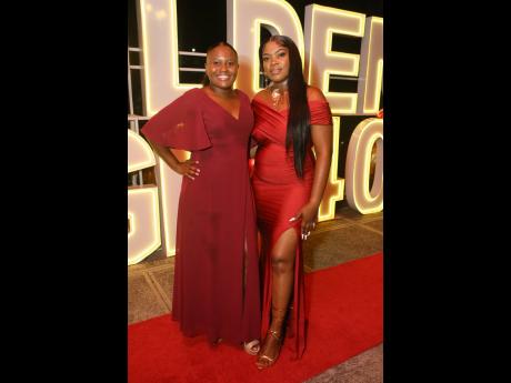 Ladies in red, Shaona McPherson (left) senior social worker, residents rehabilitation programme, and Gwendolin Whyte-Simmonds, programmes officer, are all smiles.