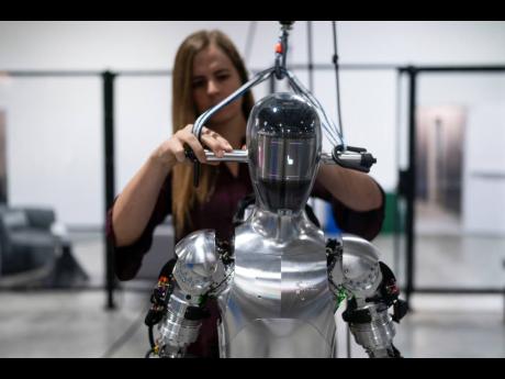 AI engineer Jenna Reher works on humanoid robot Figure 01 at Figure AI’s test facility in Sunnyvale, California in 2023. 