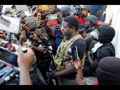 Jimmy Chérizier, a former elite police officer known as Barbecue who now runs a gang federation, holds a press conference in the Delmas 6 neighbourhood of Port-au-Prince, Haiti, Tuesday, March 5, 2024. 