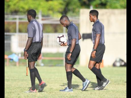 Referees at the Spanish Town Prison Oval.
