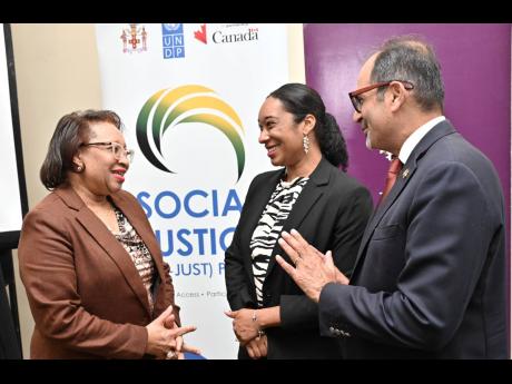 Credit: Rudolph Brown/Photographer Shehryar Sarwar (right), counsellor and head of development cooperation at the High Commission of Canada, speaks with Grace-Ann Stewart McFarlane (left), permanent secretary in the Ministry of Justice; and Lesley-Ann Ennevor, UNDP assistant resident repres