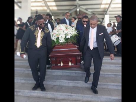 Pall-bearers removing Earle’s coffin from the Montego Bay Convention Centre in St James. 