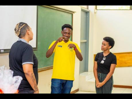 Well-known sign language interpreter Antoinette Aiken (left) with members of Sign Clubs of Jamaica Adien-Neil McLeod and Danae Campbell during the recent inaugural Sign Clubs of Jamaica Week mass meeting.