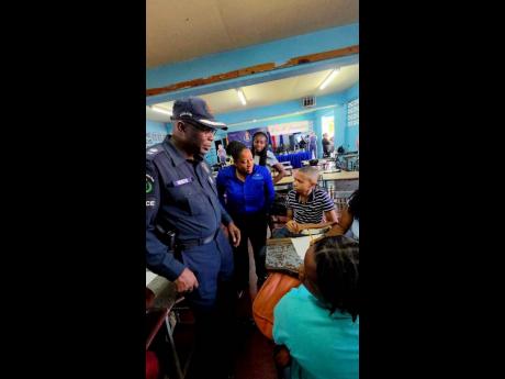 Credit: Contributed St Elizabeth Divisional Commander, Superintendent Coleridge Minto, and M&M Jamaica’s Director, Danae Mullings Makoso, observe campers as they take part in one of the week’s skill-building activities.