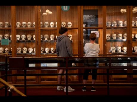 Milo Tivy, 16, and Shari Tivy, 75, look at a display of human skulls at the Mütter Museum.