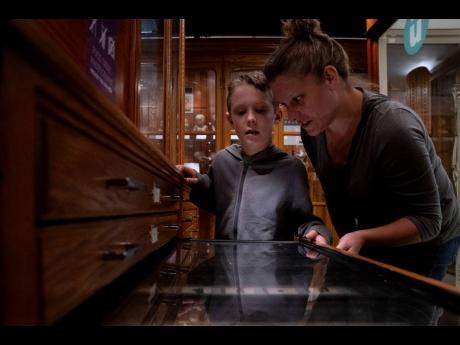 Lincoln Stollenwerk, 8, and Felice Leibowitz, 43, look at a display on objects swallowed by people at the Mütter Museum.