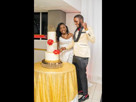 Richard and Amanda cut their vanilla wedding cake made with love by Culinary Passions Ja. 